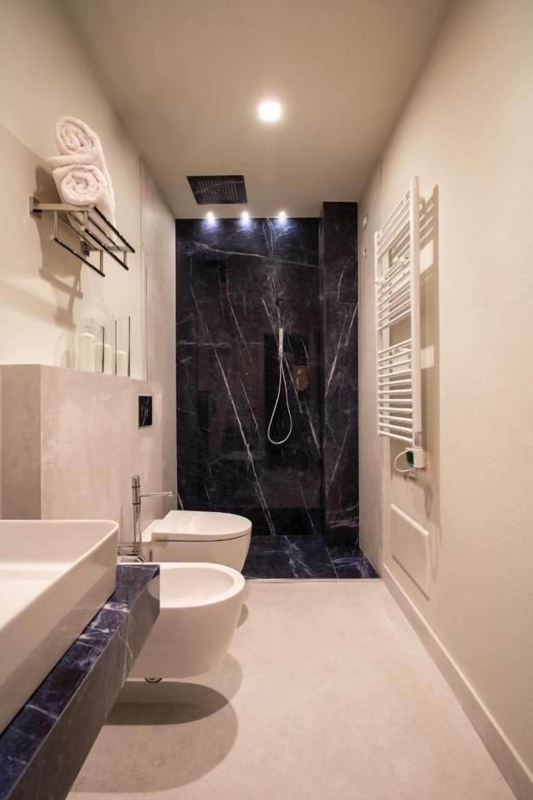 Un baño moderno con bañera, inodoro y cabina de ducha.