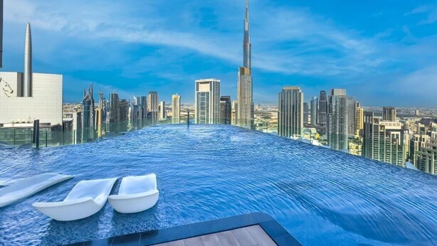 An infinity pool with a city skyline view, including a prominent skyscraper. - KeyRock Living - Skyline at Paramount (Dubai)