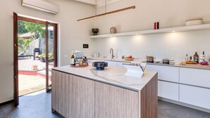 A modern kitchen with a central island, white cabinetry, and a built-in oven. - Villa Belvedere Condor - L - with Pool (Alassio)