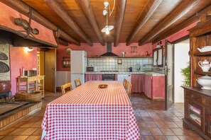 A kitchen with a checkered tablecloth, wooden beams, a tiled backsplash, and a sink. - Holiday Home 'Simon' with Mountain Views, Private Pool and Wi-Fi (San Dalmay)