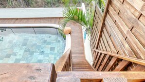 A wooden deck with a pool, surrounded by a wooden fence and a palm tree. - Comfortable apartment with terrace near Saint-Denis (La Possession)