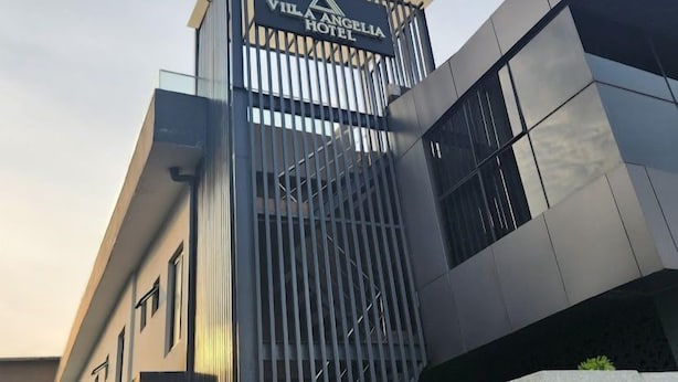 The exterior of Vila Angelina Hotel with a modern design, featuring a prominent entrance with vertical slats and a sign above. - Villa Angelia Hotel & Chinese Restaurant (Lagos)