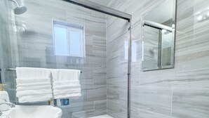 A modern bathroom with a glass-enclosed shower, a freestanding bathtub, a pedestal sink, and a toilet. - Walk to Google 3BR Home Yard & Kitchen (Mountain View)