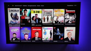 A TV channel interface with various live TV show thumbnails.
