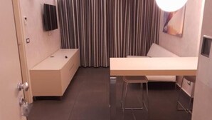 A small, modern room with a bed, a desk, and a chair. - FULL HOME. (Cosenza)