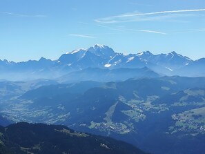 A mountain range with snow-capped peaks and a valley below.