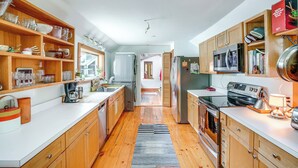 A modern kitchen with wooden cabinets, stainless steel appliances, and a central island. - 9 Mi to Dtwn Hudson: Pet-friendly Home w/ Pool (Craryville)
