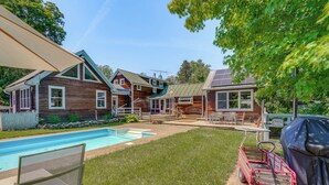 A backyard with a swimming pool, wooden houses, a barbecue grill, and a covered patio area. - 9 Mi to Dtwn Hudson: Pet-friendly Home w/ Pool (Craryville)