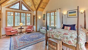 A bedroom with a four-poster bed, a large window, a rug, and a wooden ceiling. - Peaceful Shasta Cascade Getaway on 15-acre Ranch! (Weaverville)