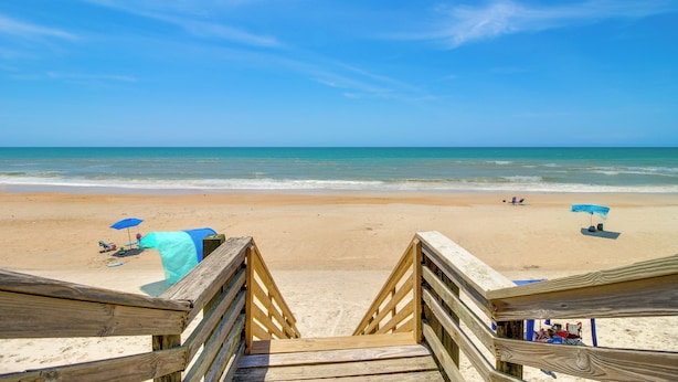 A wooden boardwalk leading to a beach with clear skies and calm waters. - Walk to North Topsail Shores: Beach House w/ Gear! (Sneads Ferry)