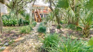A garden pathway leading to a wooden staircase with a pergola overhead. - Walk to North Topsail Shores: Beach House w/ Gear! (Sneads Ferry)