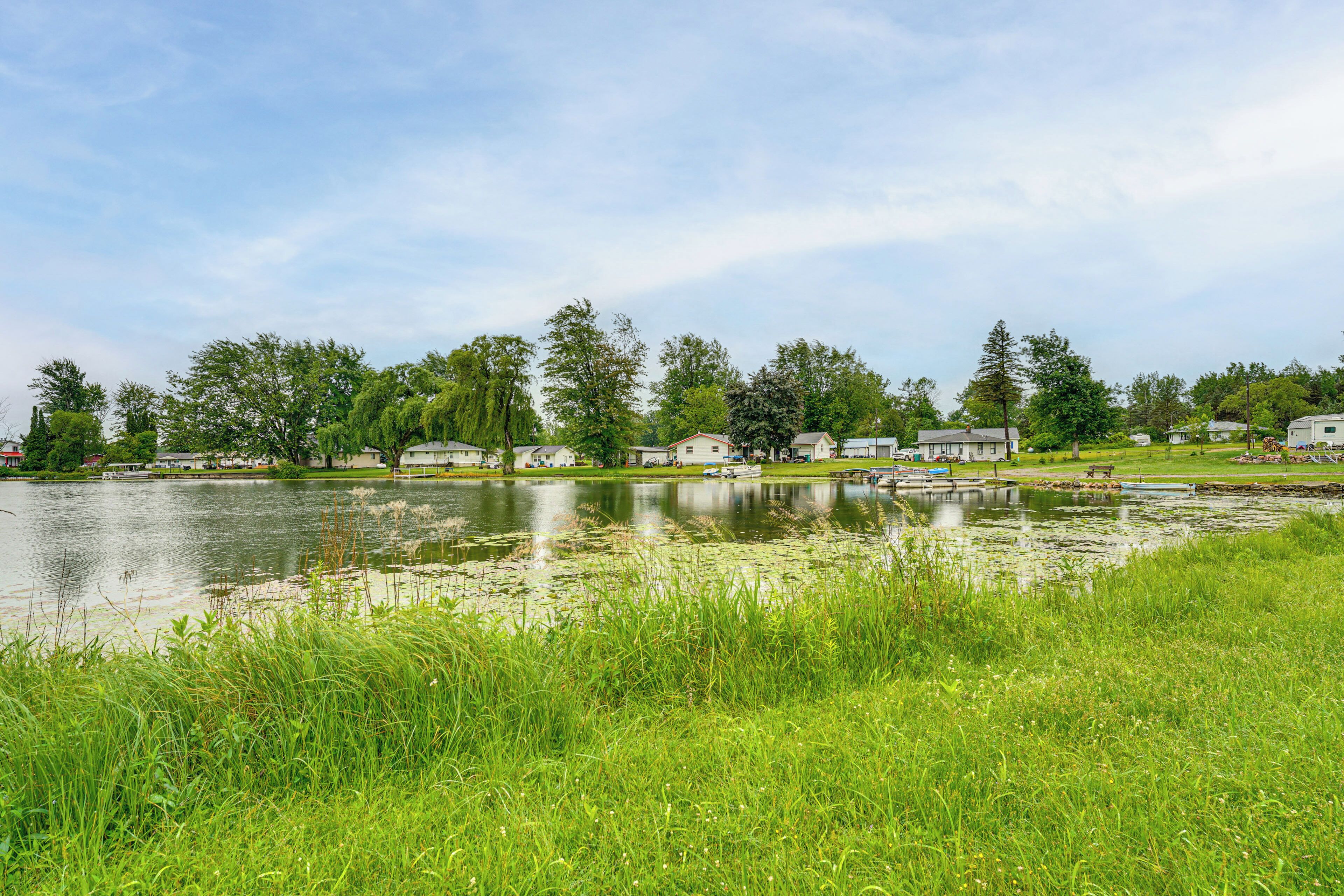 A lakeside view with houses and a dock.