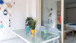 Un comedor moderno con una mesa de vidrio, sillas y adornos en la pared.