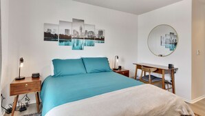 A bedroom with a bed, a desk, and a chair. There are wall art pieces and a ceiling fan. - Luxury 4BR 2 5BA Home EV Charger Pool Access (Buda)