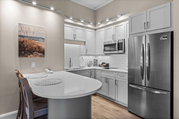 Fridge, microwave, stovetop, coffee/tea maker