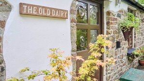 A building with a sign reading "THE OLD DAIRY" and a stone facade.