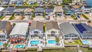 A coastal residential area with houses, a dock, and a swimming pool.