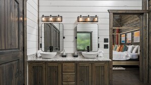 A bathroom with wooden cabinets, two sinks, and a large mirror. - Oakhaven Fell - Couples Retreat - Sauna - Cold Plunge - Hot Tub (Broken Bow)