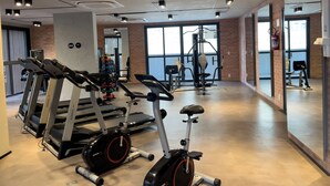 A gym with treadmills, an elliptical, and free weights. - Setin Pamplona R (Sao Paulo)