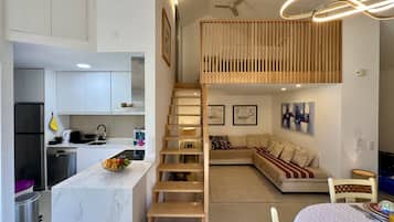 A modern interior with a kitchen, dining area, and living space.