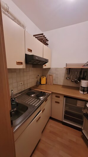 Fridge, coffee/tea maker, high chair, cookware/dishes/utensils