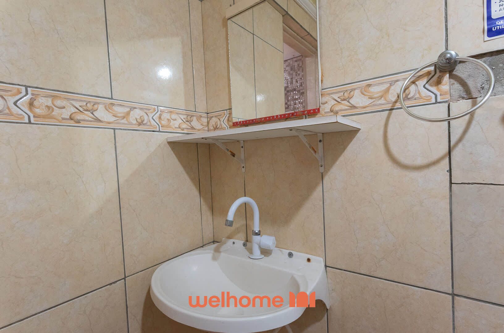 Ein Badezimmer mit Waschbecken, Spiegel und Handtuchhalter.