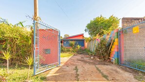 A gated property with a pathway leading to a building.
