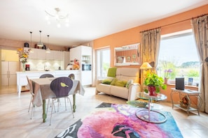 A modern living space with a kitchen, dining area, and seating area.