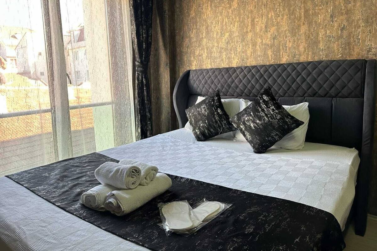 Ein Hotelzimmer mit Bett, Kissen und Handtüchern.