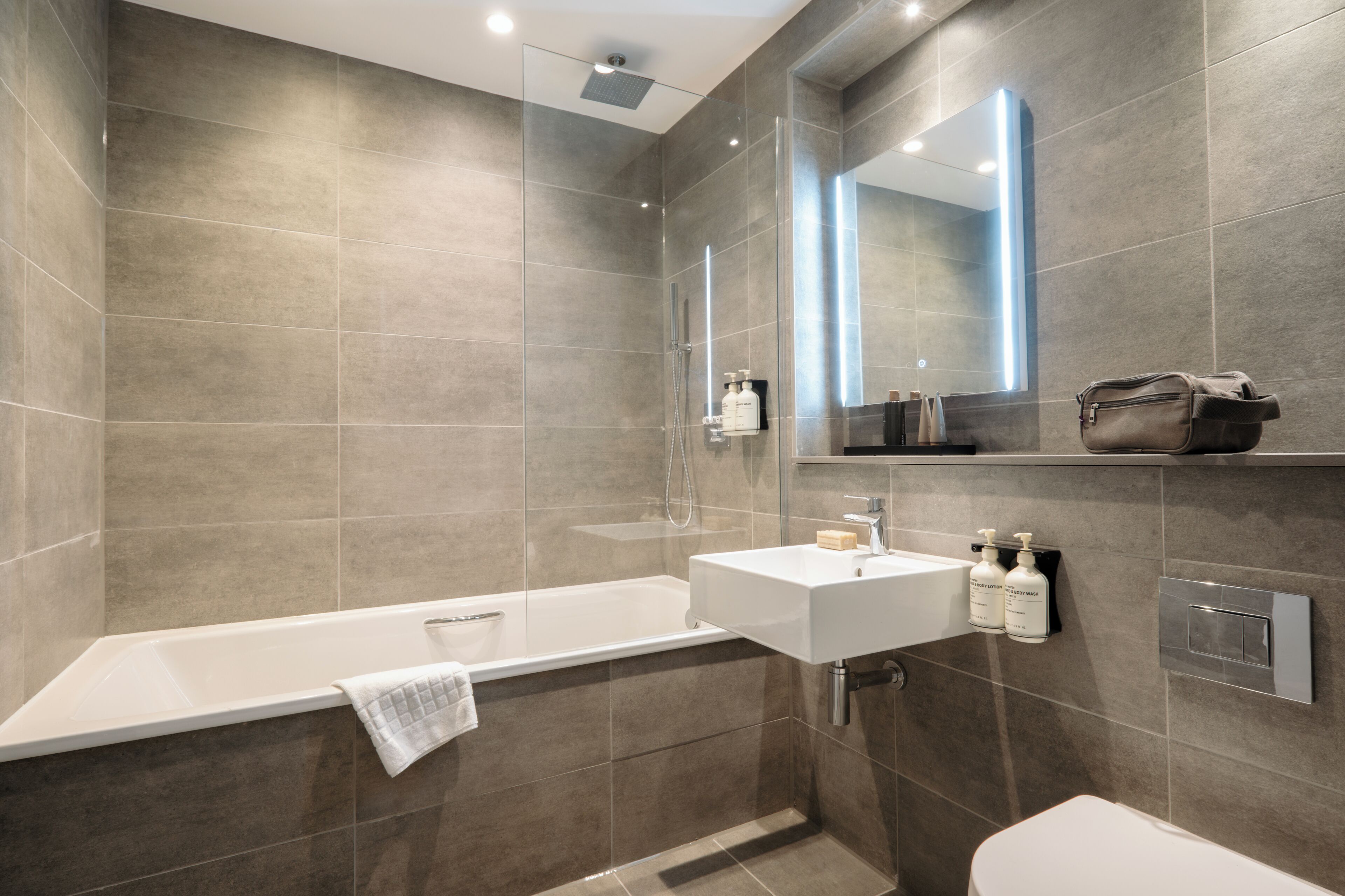 A modern bathroom with a bathtub, a sink, and a toilet.
