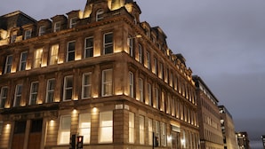 A historic building with multiple stories, large windows, and classic architectural details.