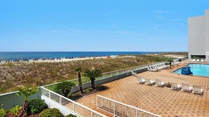 A beachside pool area with lounge chairs and a view of the beach and ocean. - 🌊Gulf View-Steps to Beach-Heated Pool-Islander Beach Resort 2002🌅 (Fort Walton Beach)