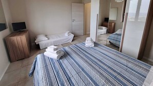 A modern bedroom with a large bed, a bedside table, a TV, and a wardrobe. - Villa for family/friends, few minutes from the most beautiful medieval villages (Umbria)