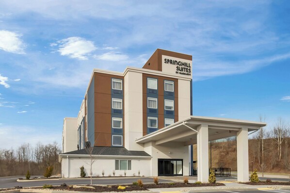 A modern hotel with a prominent sign reading "Springhill Suites by Marriott." It features a multi-story building with a flat roof, large windows, and a covered entrance area. - Springhill Suites Pittsburgh Airport (Coraopolis)