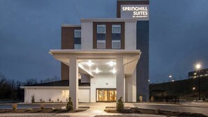 A modern hotel entrance with a covered walkway, a sign for Springhill Suites by Marriott, and a parking area. - Springhill Suites Pittsburgh Airport (Coraopolis)