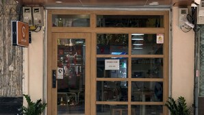 A storefront with a sign reading 'SHYM CAFE' and a sign indicating 'OPENING SOON.'