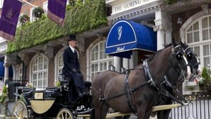 A horse-drawn carriage in front of The Goring Hotel, with a traditional building facade and a blue awning. - The Goring (London)
