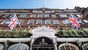 The Goring Hotel with a classic facade, two flags, and a prominent entrance. - Goring Hotel (London)