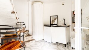 A compact kitchen with a sink, a mirror, and a refrigerator. - Holiday Home 'Le Moulin De Pen Hoêt' with Shared Garden (Vertou)