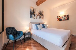 Desk, iron/ironing board, bed sheets