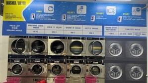A laundromat with multiple washing machines and dryers, price list, and instructions on the wall. - C&Y Horizon Suites Homestay Sepang - KLIA Transit - Near XiaMen University (Sepang)