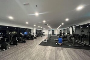 A gym with treadmills, elliptical machines, and weightlifting equipment. - C&Y Horizon Suites Homestay Sepang - KLIA Transit - Near XiaMen University (Sepang)