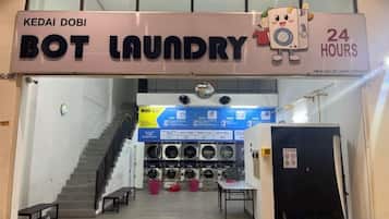 A laundry facility with a sign indicating 24-hour service.