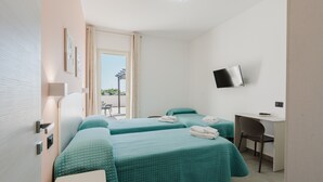 A hotel room with two beds, a desk, a chair, a TV, and a window with a view. - Bed And Breakfast Champagneria 'Room 4' with Shared Terrace, Wi-Fi and Air Conditioning (Castelvetrano)
