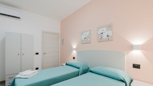 A bedroom with two beds, a wardrobe, and wall-mounted lights. - Bed And Breakfast Champagneria 'Room 4' with Shared Terrace, Wi-Fi and Air Conditioning (Castelvetrano)