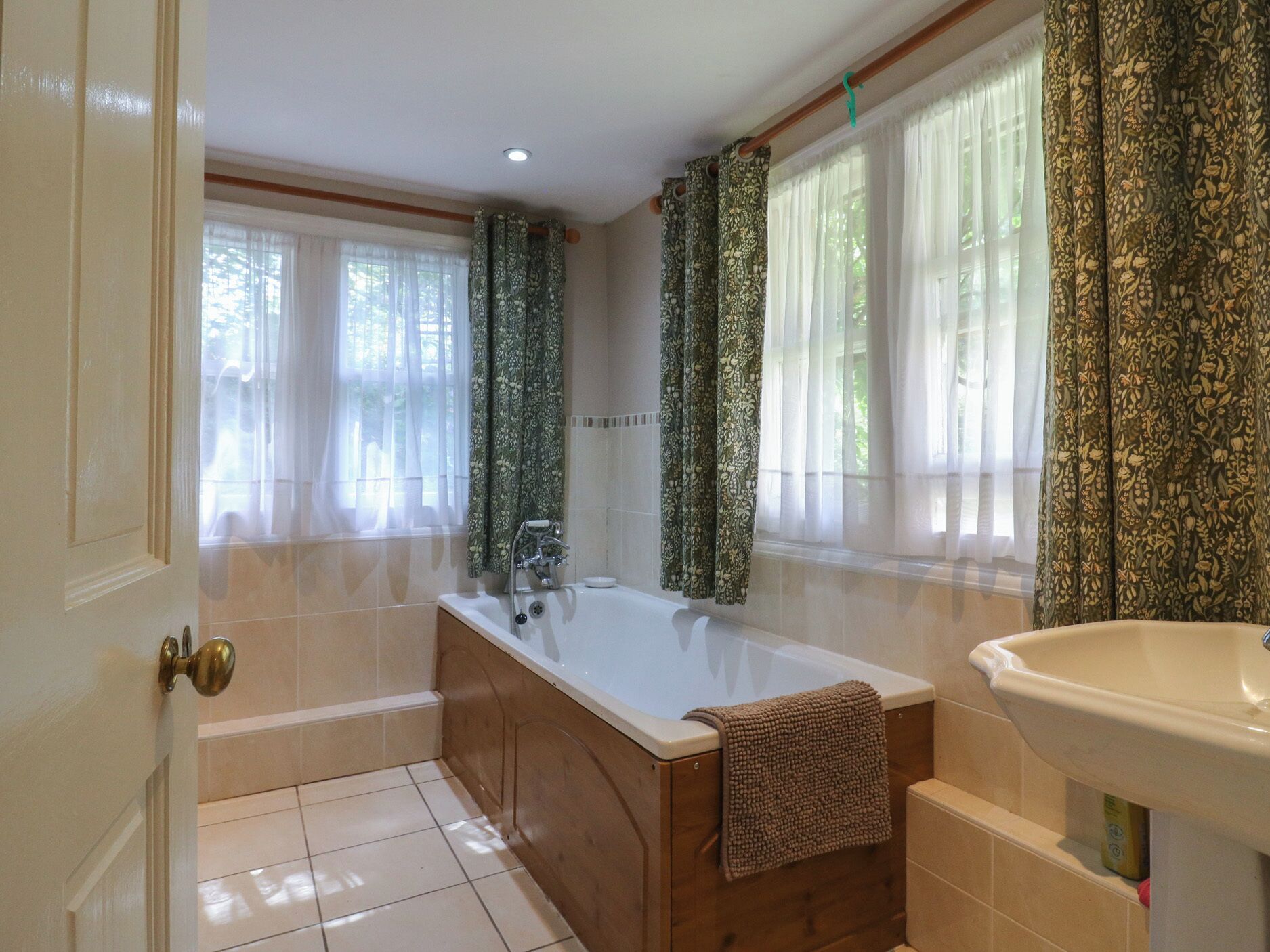 A bathroom with a bathtub, a sink, and a toilet.