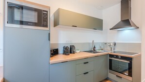A compact kitchen with a built-in microwave, a coffee maker, a toaster, and an oven. - Gustave - Proche centre-ville de Nantes (Nantes)