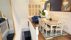 A dining area with a wooden floor, white furniture, and a chandelier. - Stunning 4 Bed Town House w/ Roof Terrace in Farringdon / St Paul's Cathedral (London)