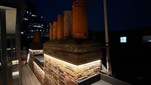 A rooftop with a brick chimney, a flat surface, and a wooden deck. - Stunning 4 Bed Town House w/ Roof Terrace in Farringdon / St Paul's Cathedral (London)
