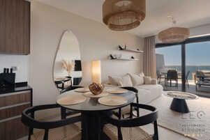 Deluxe Apartment | Living area | 41-cm LCD TV with cable channels